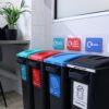 black plastic office recycling bins